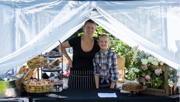 Photograph of a woman and a girl at a market stall